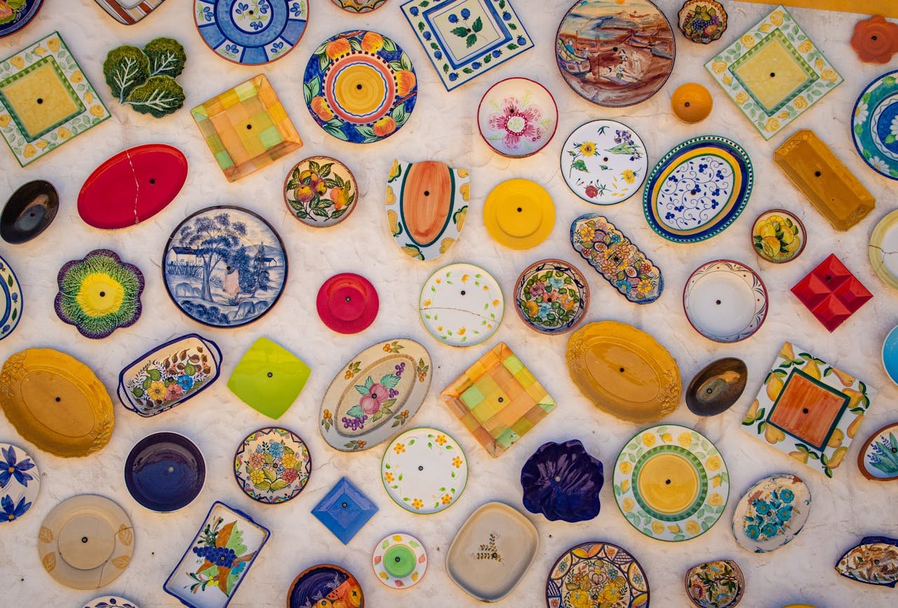 Colorful array of decorative ceramic plates exhibited in Faro, Portugal.